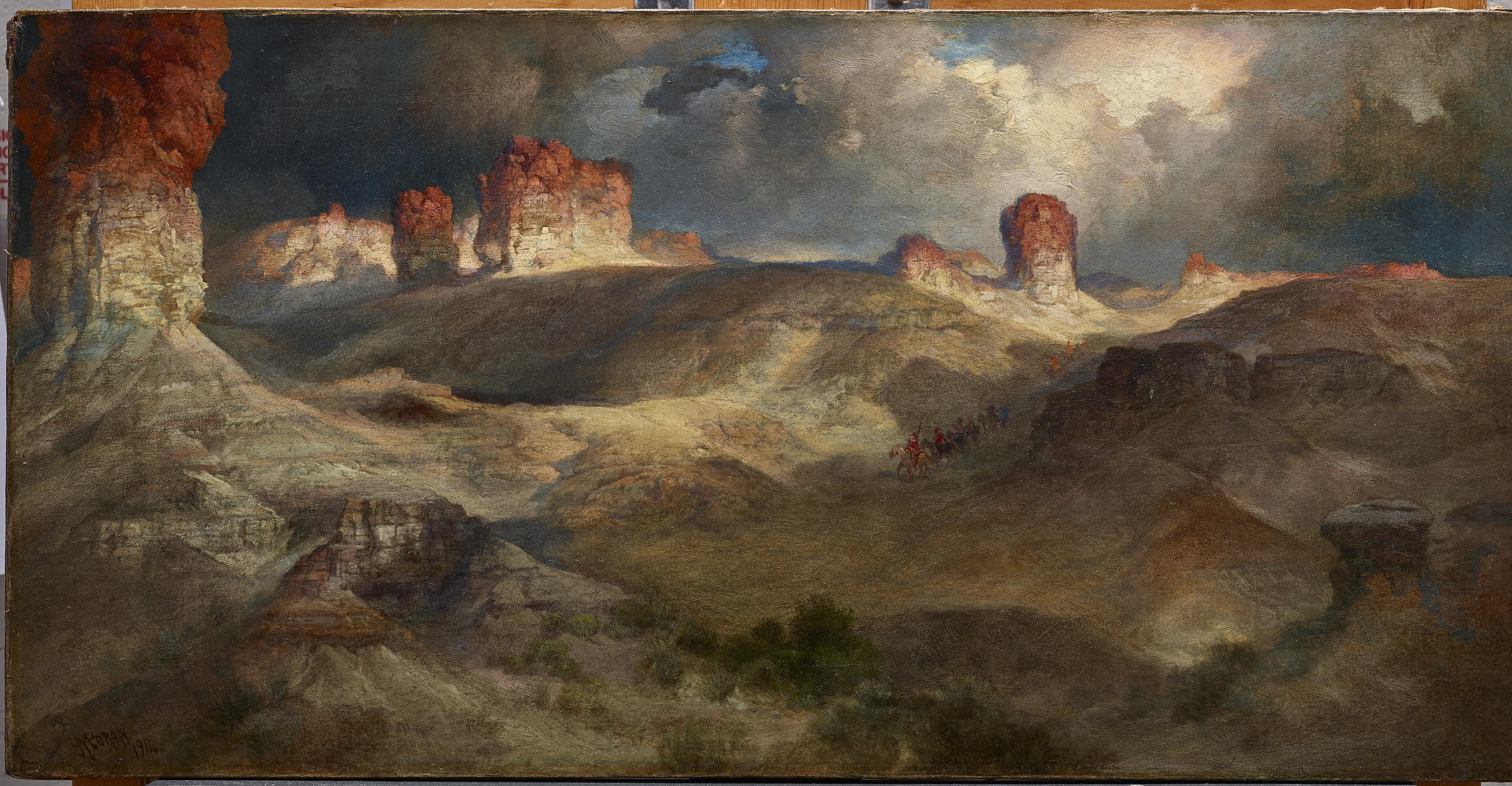 Panoramic painting of pine-topped buttes rising over open Wyoming country.